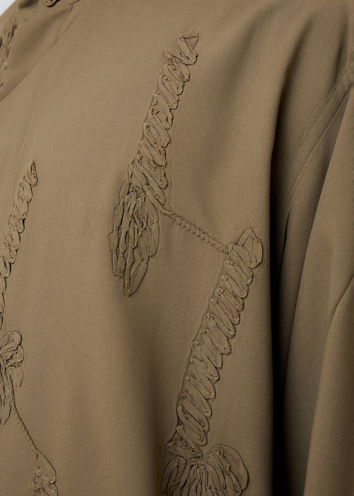 A model wears the Homme Plisse Issey Miyake EMBROIDERY PRESS SHIRT prêt à porter.