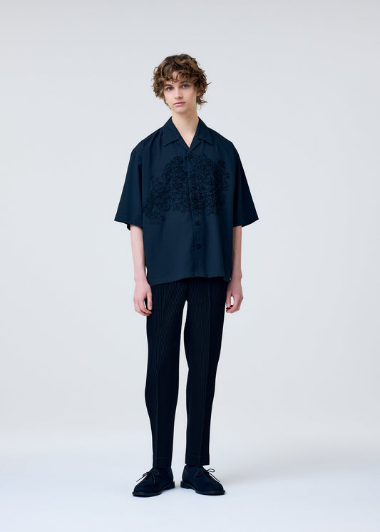 A model wears the Homme Plisse Issey Miyake EMBROIDERY PRESS SHIRT prêt à porter.