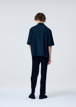 A model wears the Homme Plisse Issey Miyake EMBROIDERY PRESS SHIRT prêt à porter.