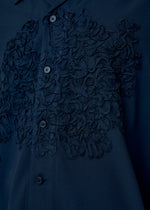 A model wears the Homme Plisse Issey Miyake EMBROIDERY PRESS SHIRT prêt à porter.