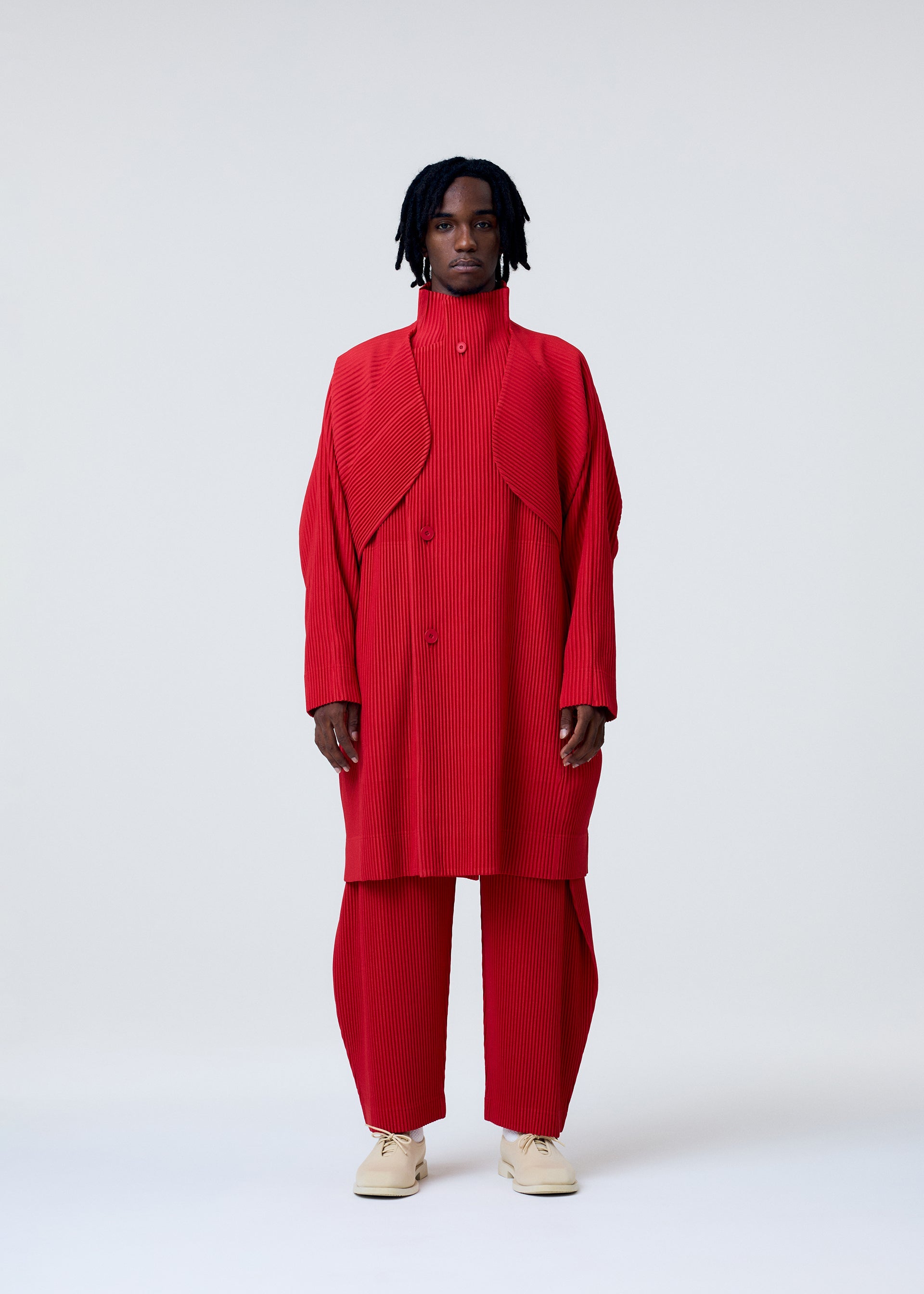 A model wears the HOMME PLISSE ISSEY MIYAKE COVER AND FOLD prêt à porter.