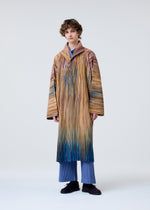 A model wears the Homme Plisse Issey Miyake PAINT BRUSH CLOSE UP prêt à porter.