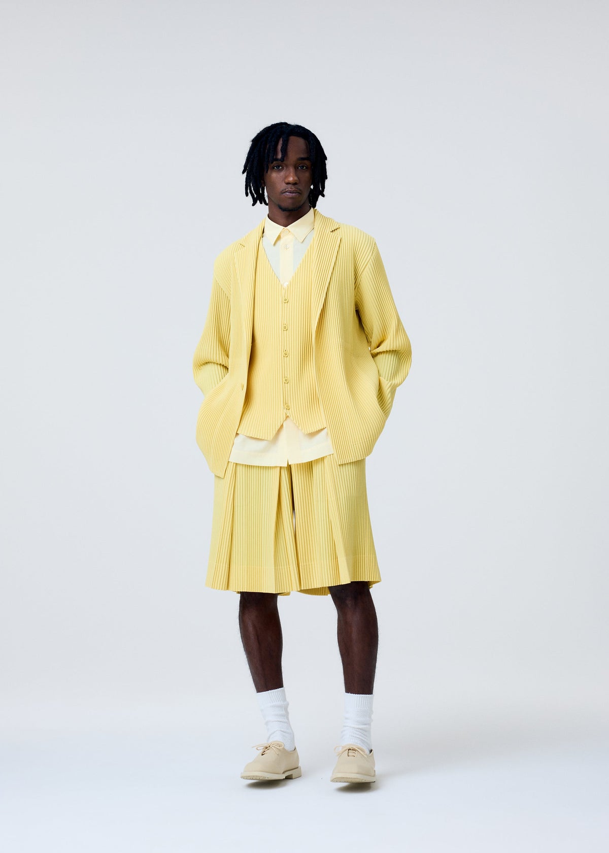 A model wears the Homme Plisse Issey Miyake TAILORED PLEATS 2 jacket.