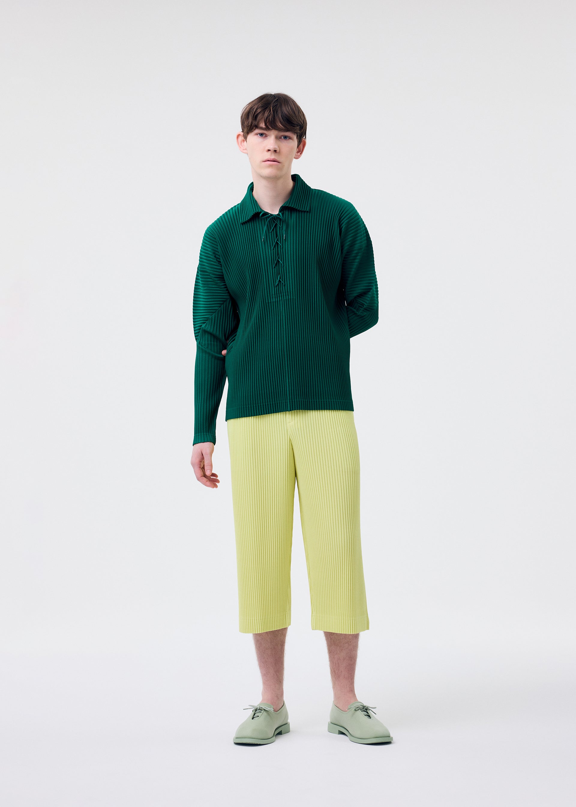 A model wears the Homme Plisse Issey Miyake MONTHLY COLORS MAY trousers.