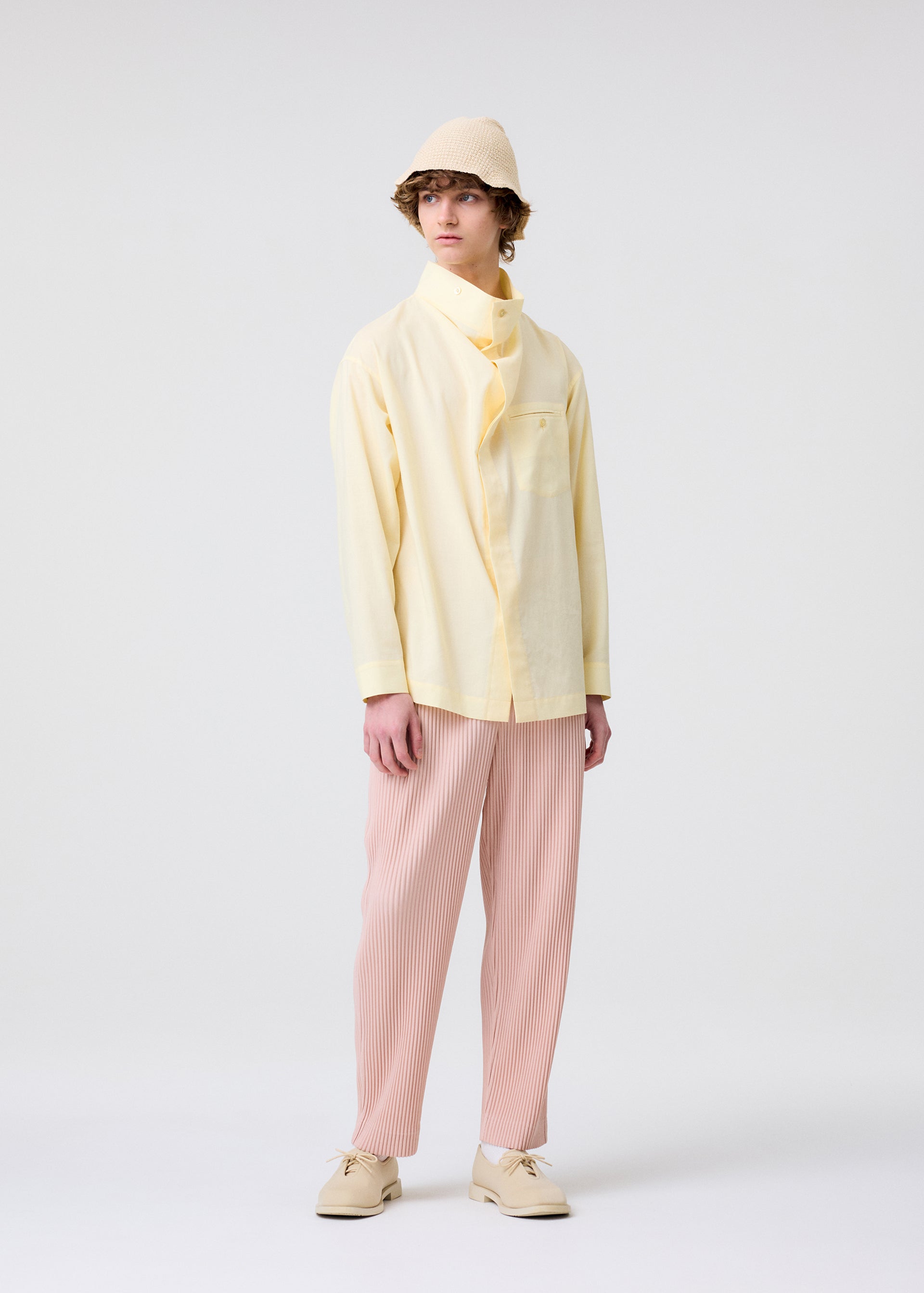 A model wears the Homme Plisse Issey Miyake COLOR PLEATS 2 trousers.