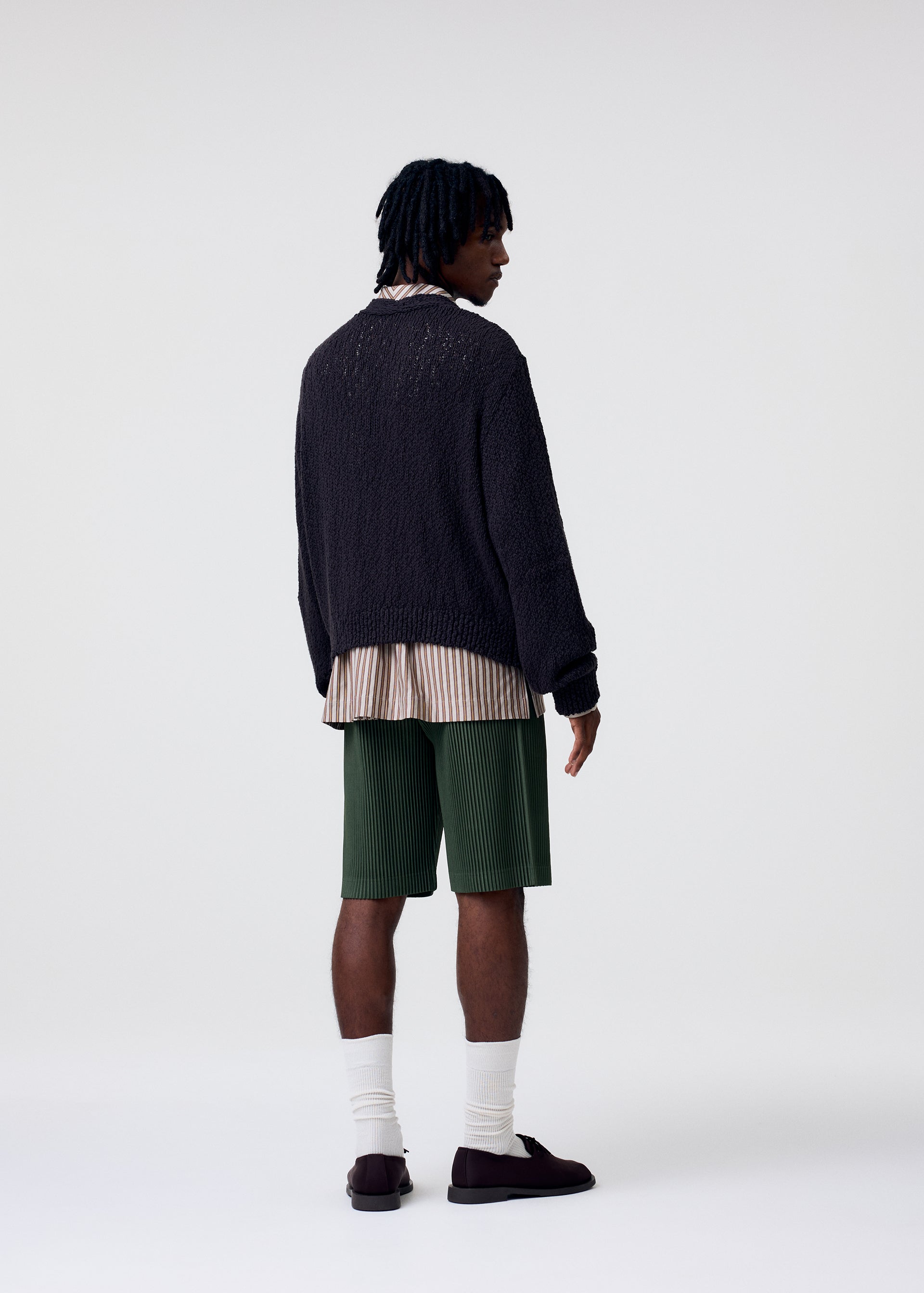 A model wears the Homme Plisse Issey Miyake COLOR PLEATS 2 trousers.