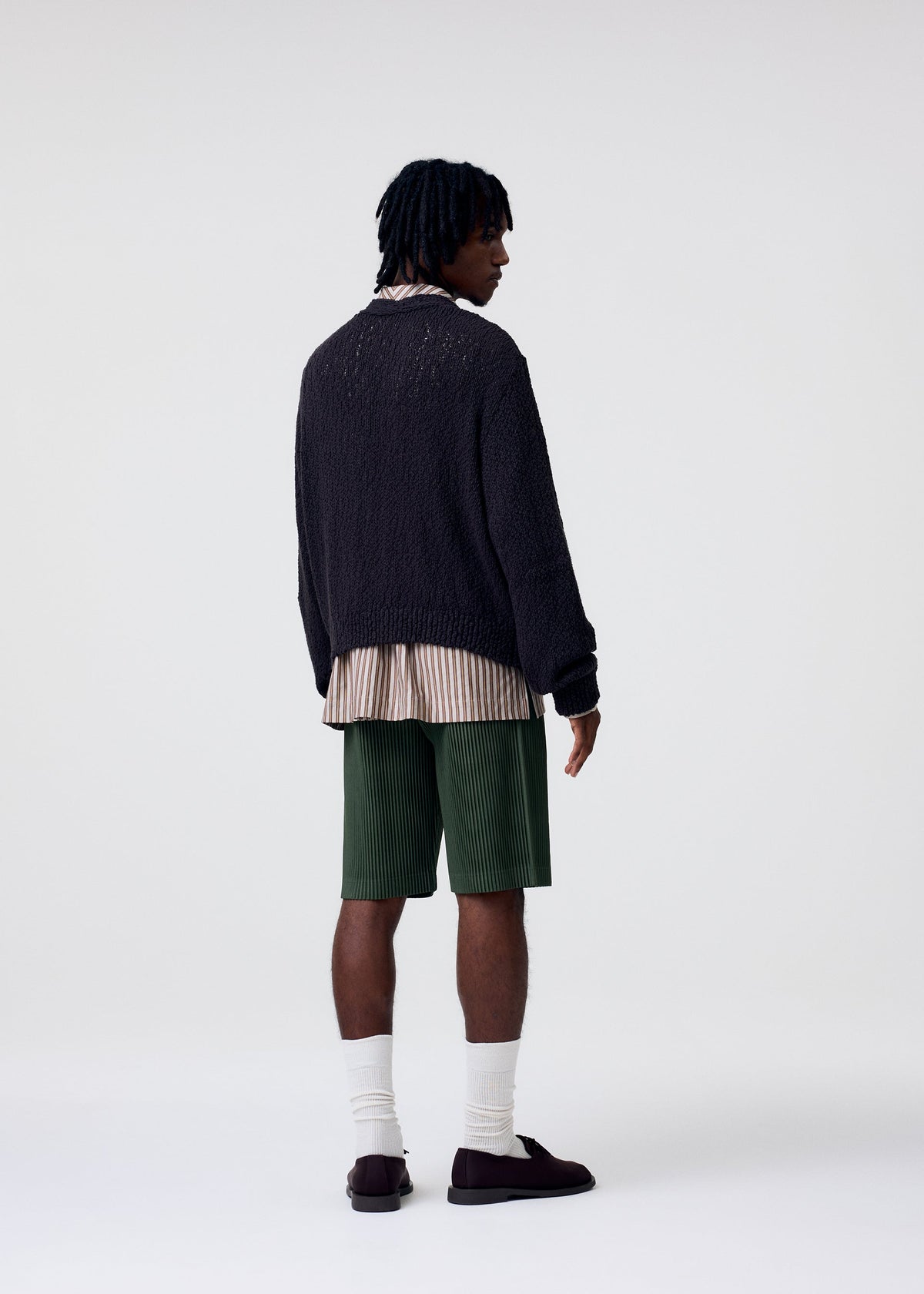 A model wears the Homme Plisse Issey Miyake COLOR PLEATS 2 trousers.