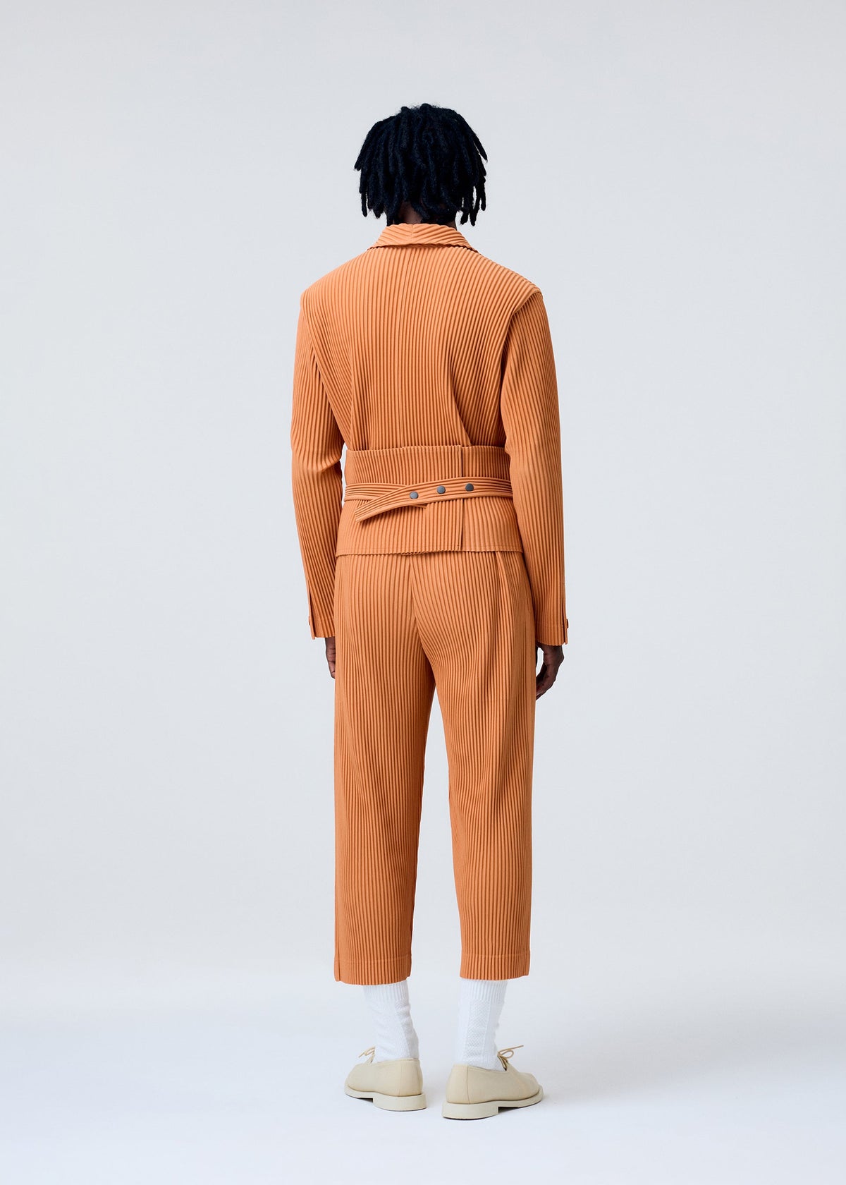 A model wears the Homme Plisse Issey Miyake TAILORED PLEATS 2 pants.