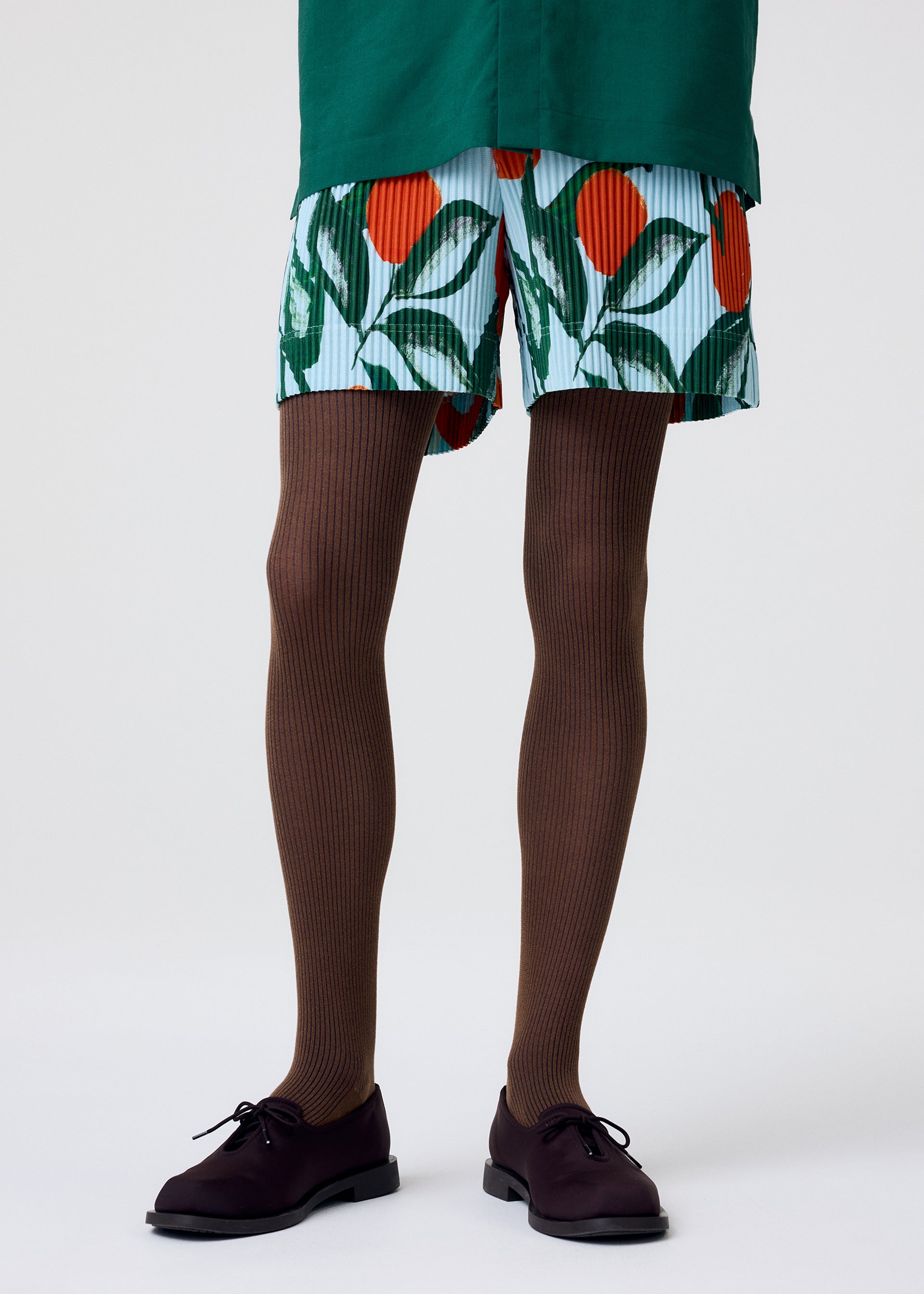 A model wears the Homme Plisse Issey Miyake FRUITS VEGETABLES trousers.