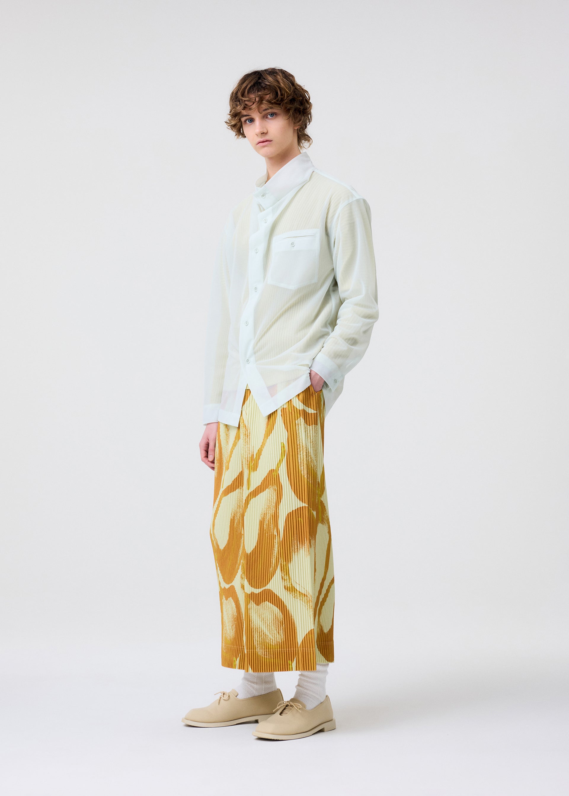 A model wears the Homme Plisse Issey Miyake FRUITS VEGETABLES skirt.