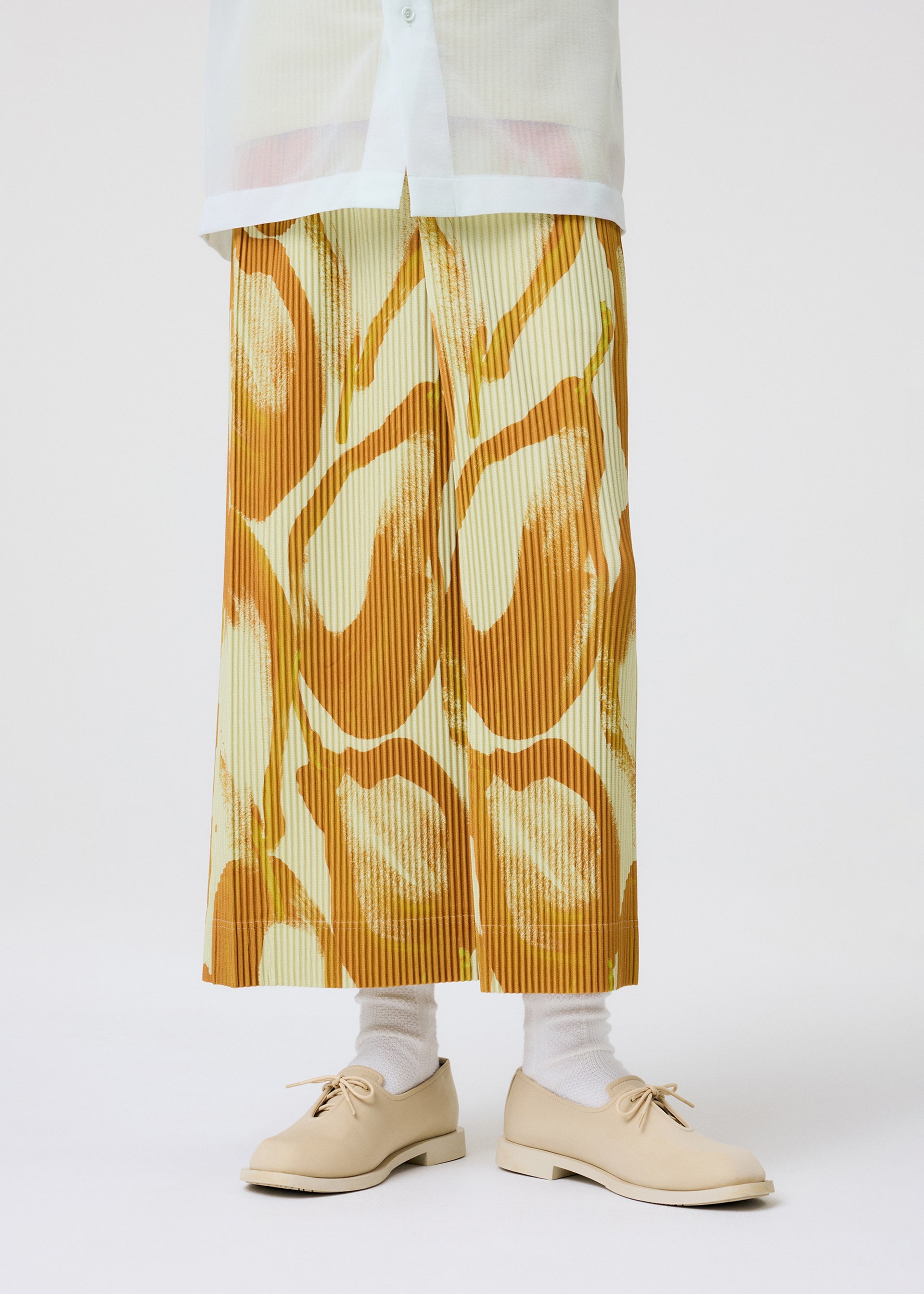 A model wears the Homme Plisse Issey Miyake FRUITS VEGETABLES skirt.