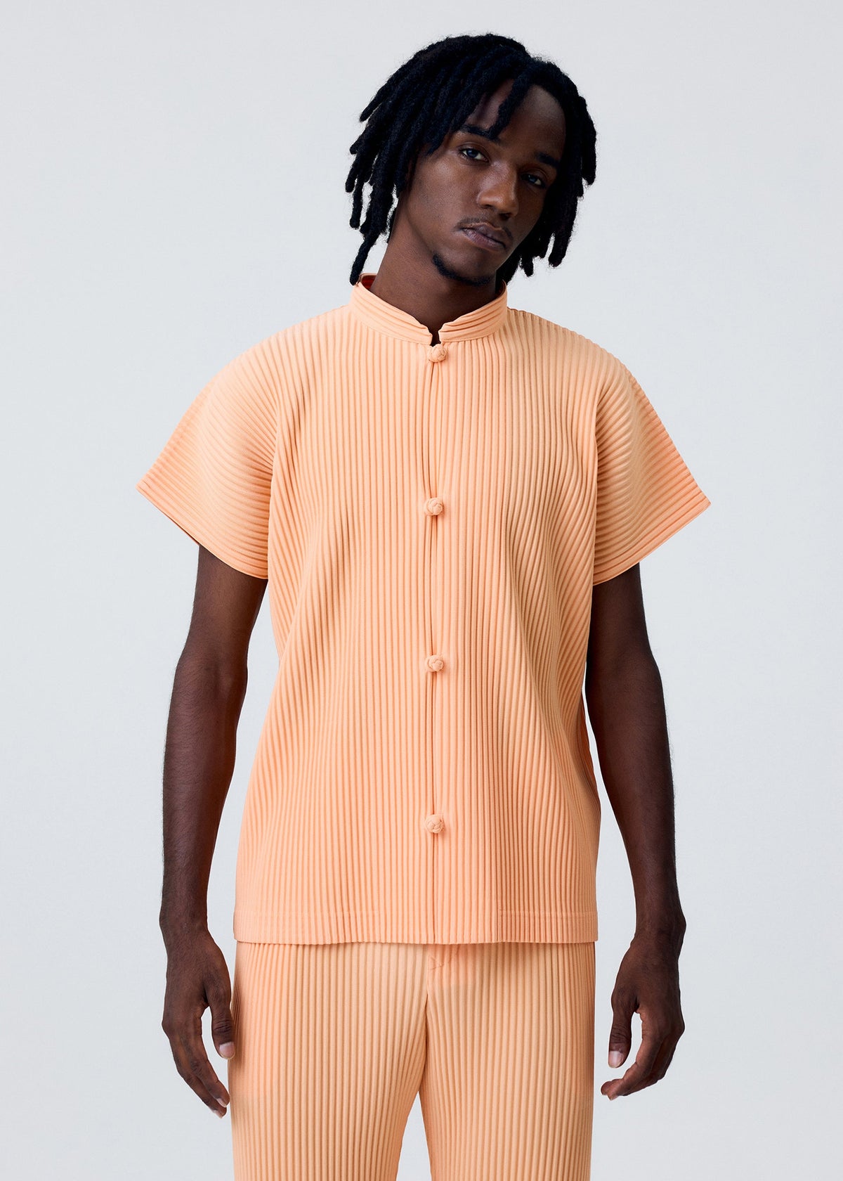 A model wears the Homme Plisse Issey Miyake MONTHLY COLORS   APRIL shirt.