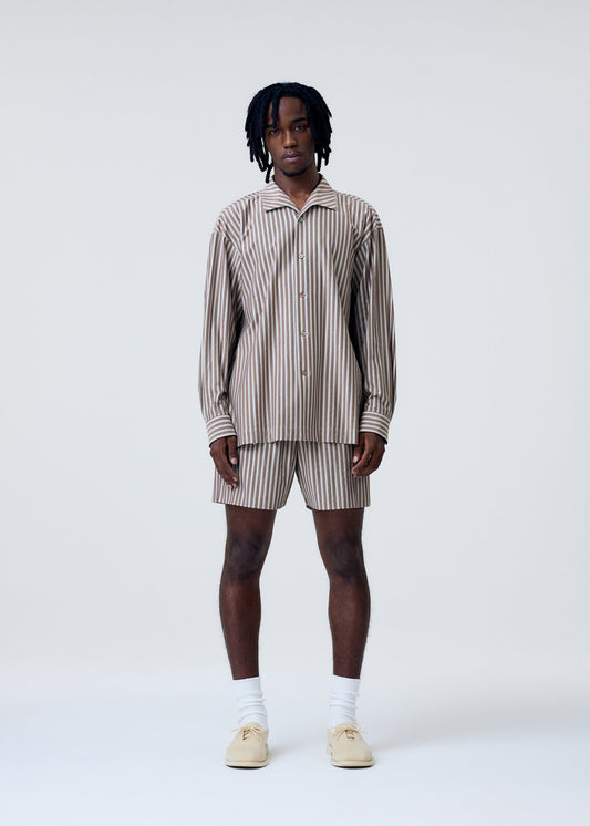 A model wears the Homme Plisse Issey Miyake STRIPE JERSEY shirt.