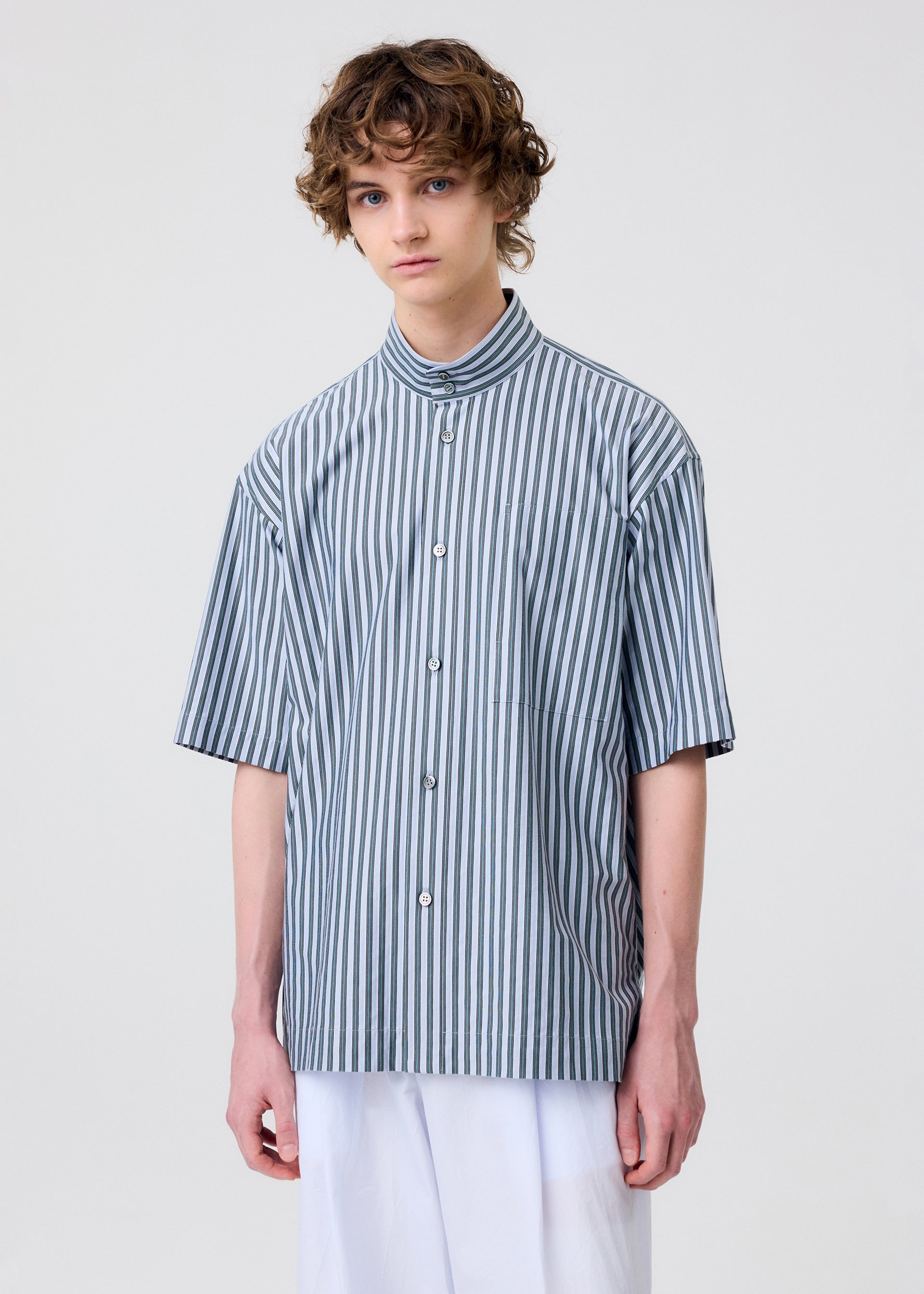 A model wears the Homme Plisse Issey Miyake STRIPE JERSEY shirt.