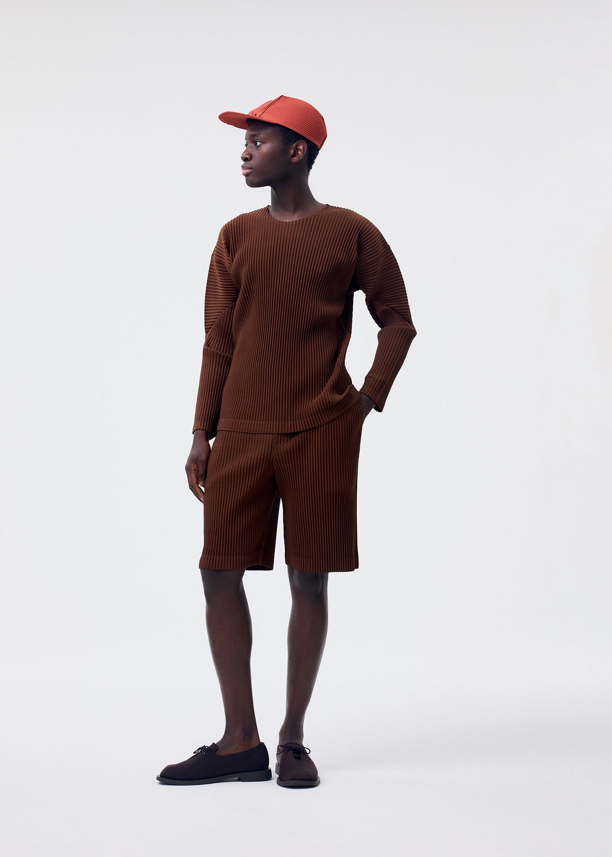 A model wears the Homme Plisse Issey Miyake COLOR PLEATS 2 top.