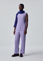 A model wears the HOMME PLISSÉ ISSEY MIYAKE RUSTIC MESH STOLE rustic-mesh-stole-stole-ivory-1.