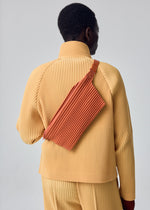 A model wears the HOMME PLISSÉ ISSEY MIYAKE PLEATS SLIM BAG pleats-slim-bag-bag-blue-purple-1.