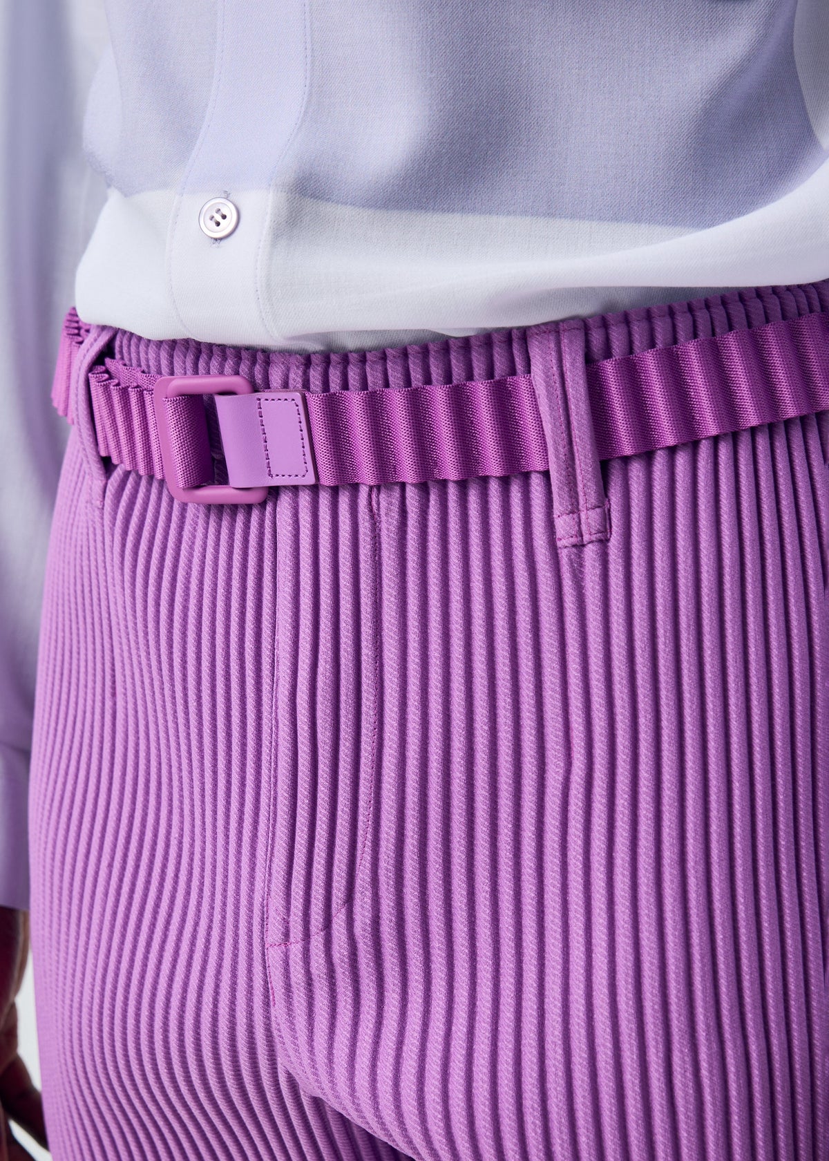 A model wears the HOMME PLISSÉ ISSEY MIYAKE PLEATS BELT belt.