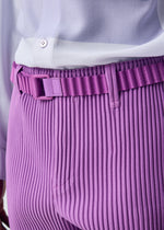 A model wears the HOMME PLISSÉ ISSEY MIYAKE PLEATS BELT belt.
