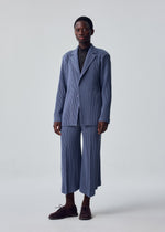 A model wears the HOMME PLISSÉ ISSEY MIYAKE KERSEY PLEATS jacket.