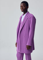 A model wears the HOMME PLISSÉ ISSEY MIYAKE KERSEY PLEATS jacket.