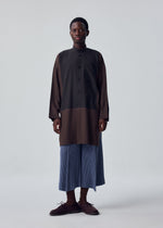 A model wears the HOMME PLISSÉ ISSEY MIYAKE KERSEY PLEATS trousers.
