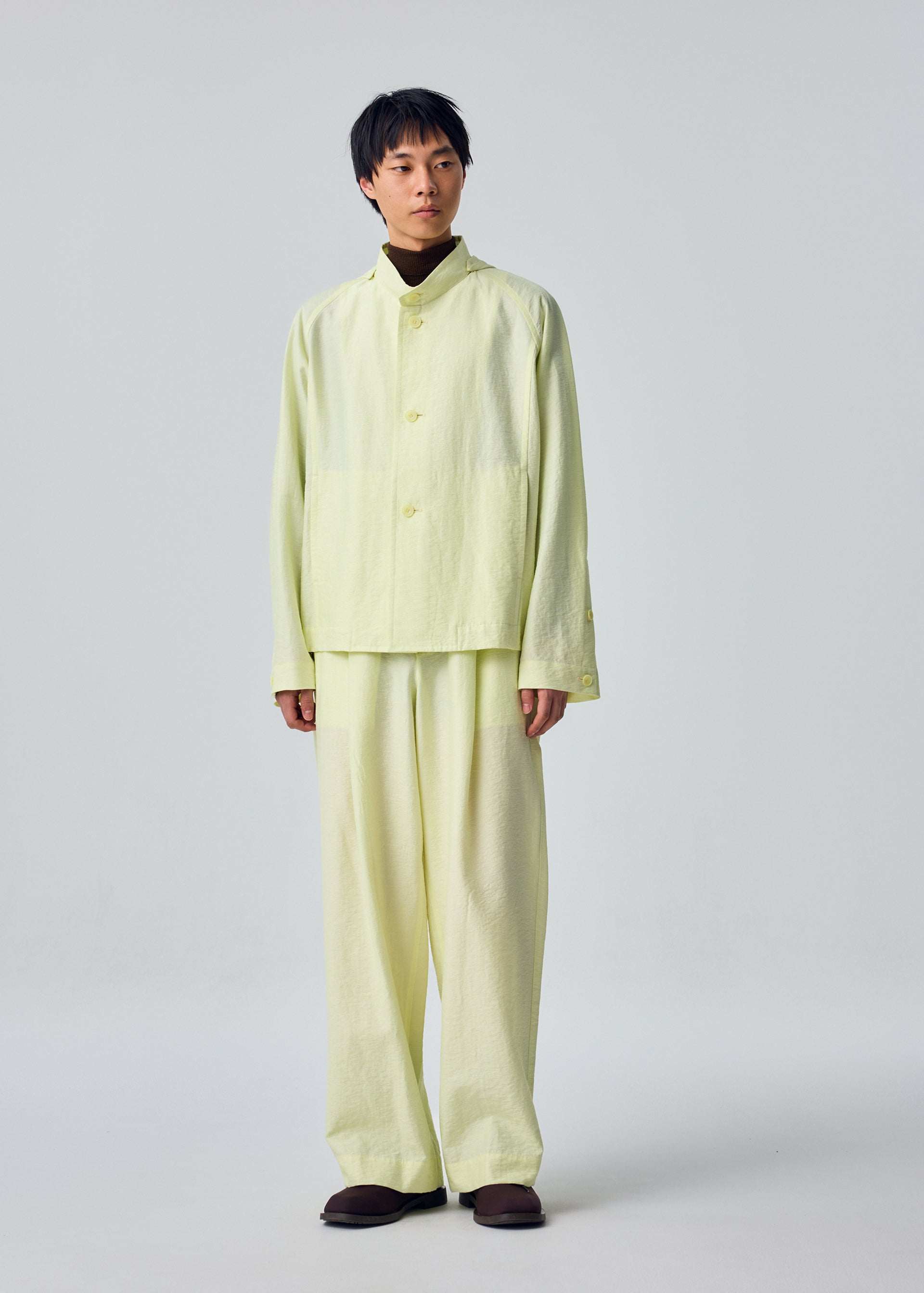 A model wears the HOMME PLISSÉ ISSEY MIYAKE OPACITY trousers.