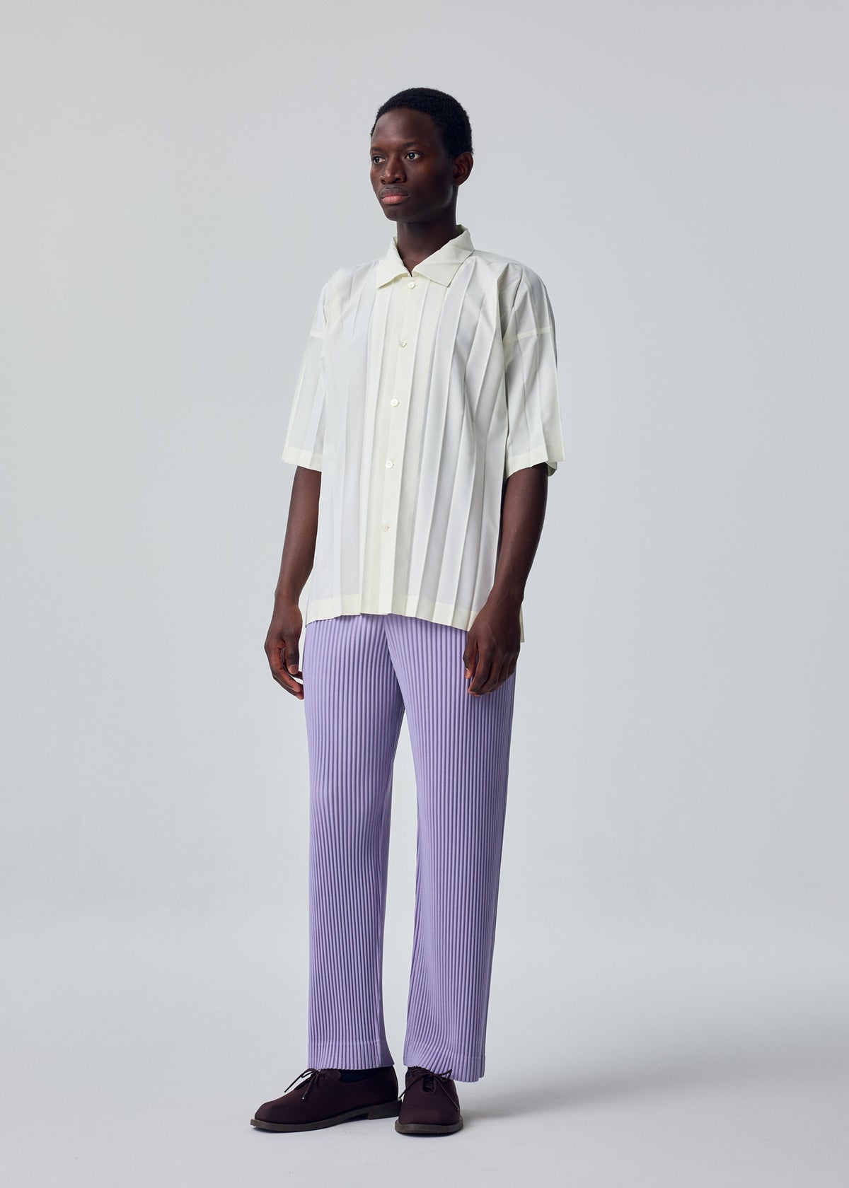 A model wears the HOMME PLISSÉ ISSEY MIYAKE EDGE SHIRT edge-shirt-shirt-white-fw26.