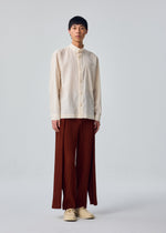 A model wears the HOMME PLISSÉ ISSEY MIYAKE PL RAMIE SHIRT pl-ramie-shirt-shirt-brown-4.
