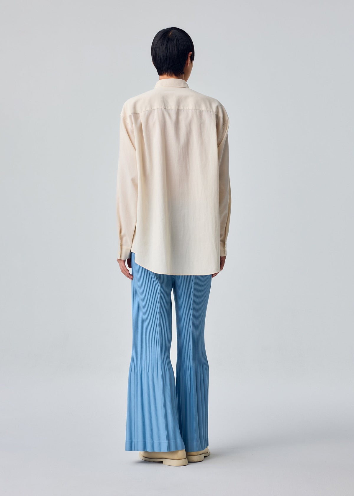 A model wears the HOMME PLISSÉ ISSEY MIYAKE PL RAMIE SHIRT pl-ramie-shirt-shirt-brown-5.