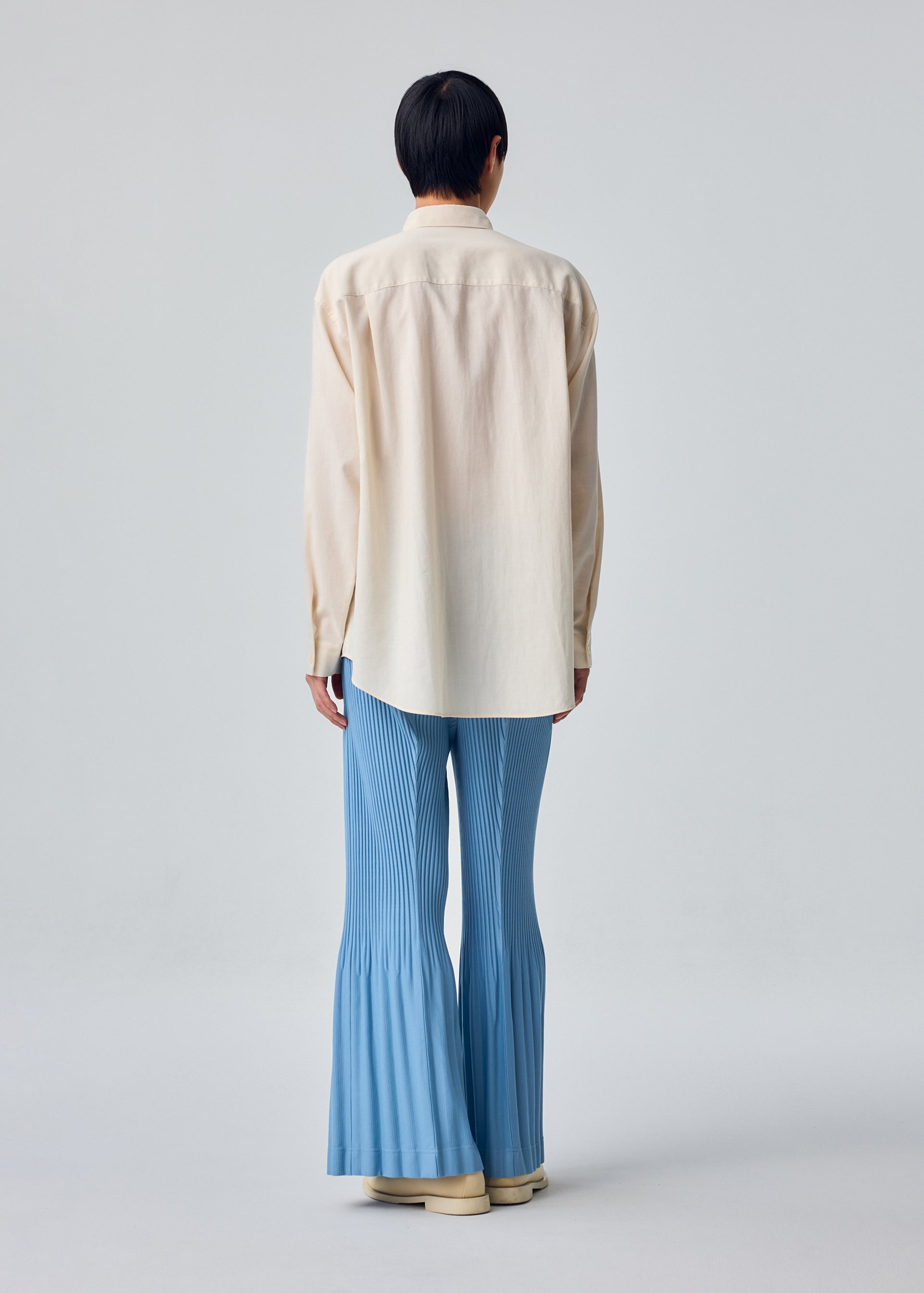 A model wears the HOMME PLISSÉ ISSEY MIYAKE PL RAMIE SHIRT pl-ramie-shirt-shirt-brown-5.
