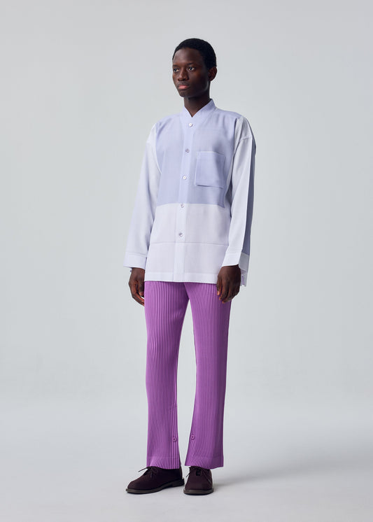 A model wears the HOMME PLISSÉ ISSEY MIYAKE PRESS SHIRT shirt.