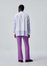 A model wears the HOMME PLISSÉ ISSEY MIYAKE PRESS SHIRT shirt.