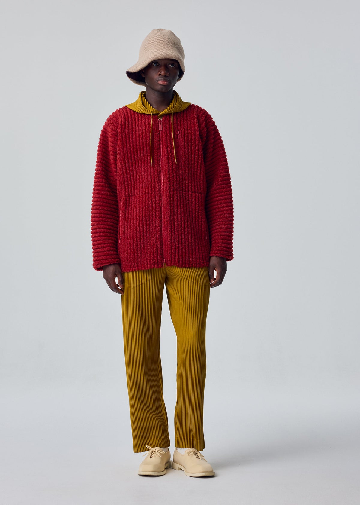 A model wears the HOMME PLISSÉ ISSEY MIYAKE FLEECE PLEATS blouson.