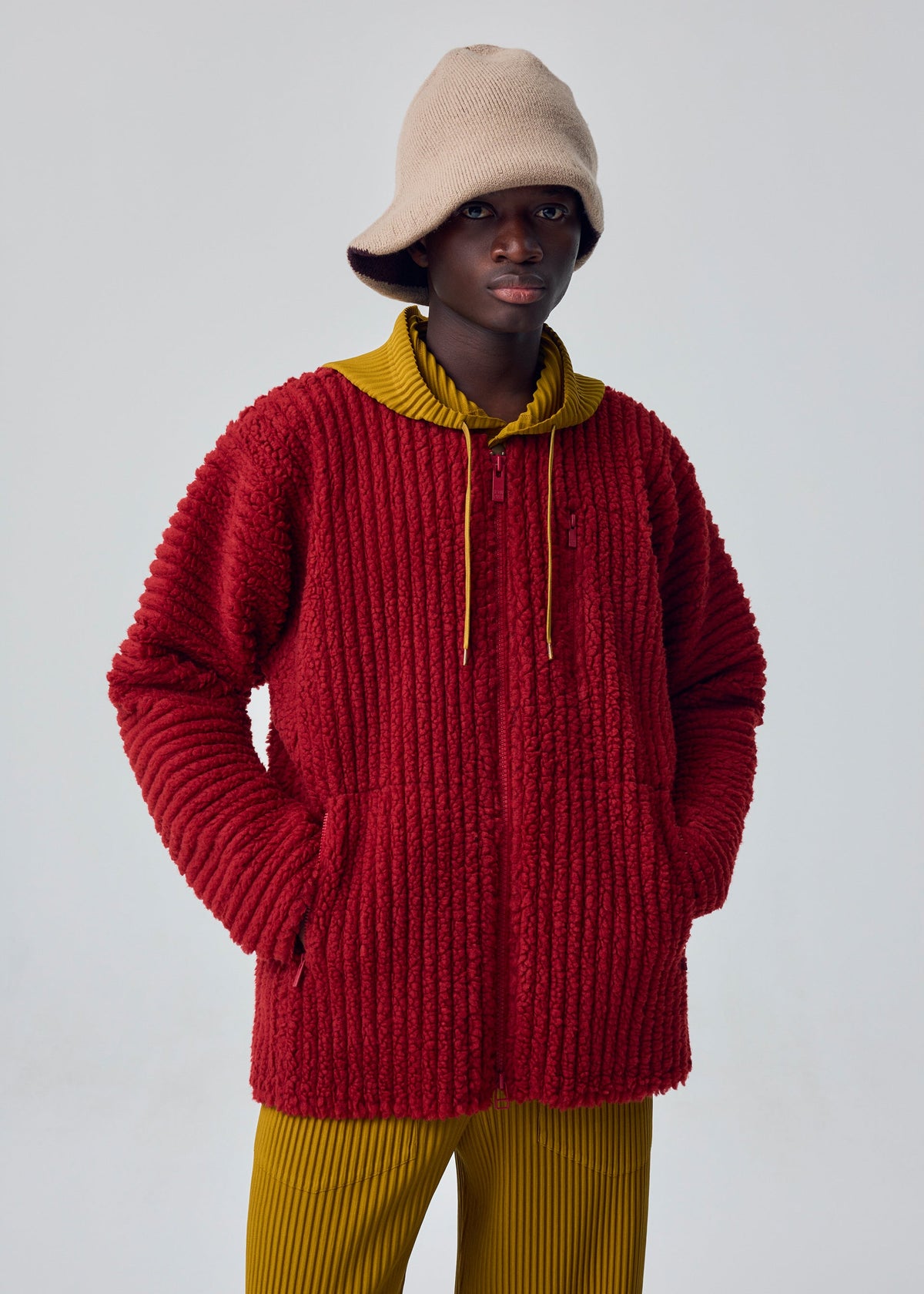 A model wears the HOMME PLISSÉ ISSEY MIYAKE FLEECE PLEATS blouson.