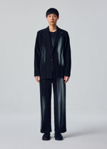 A model wears the HOMME PLISSÉ ISSEY MIYAKE IN THE SHADOW jacket.