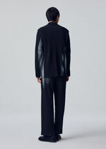 A model wears the HOMME PLISSÉ ISSEY MIYAKE IN THE SHADOW jacket.