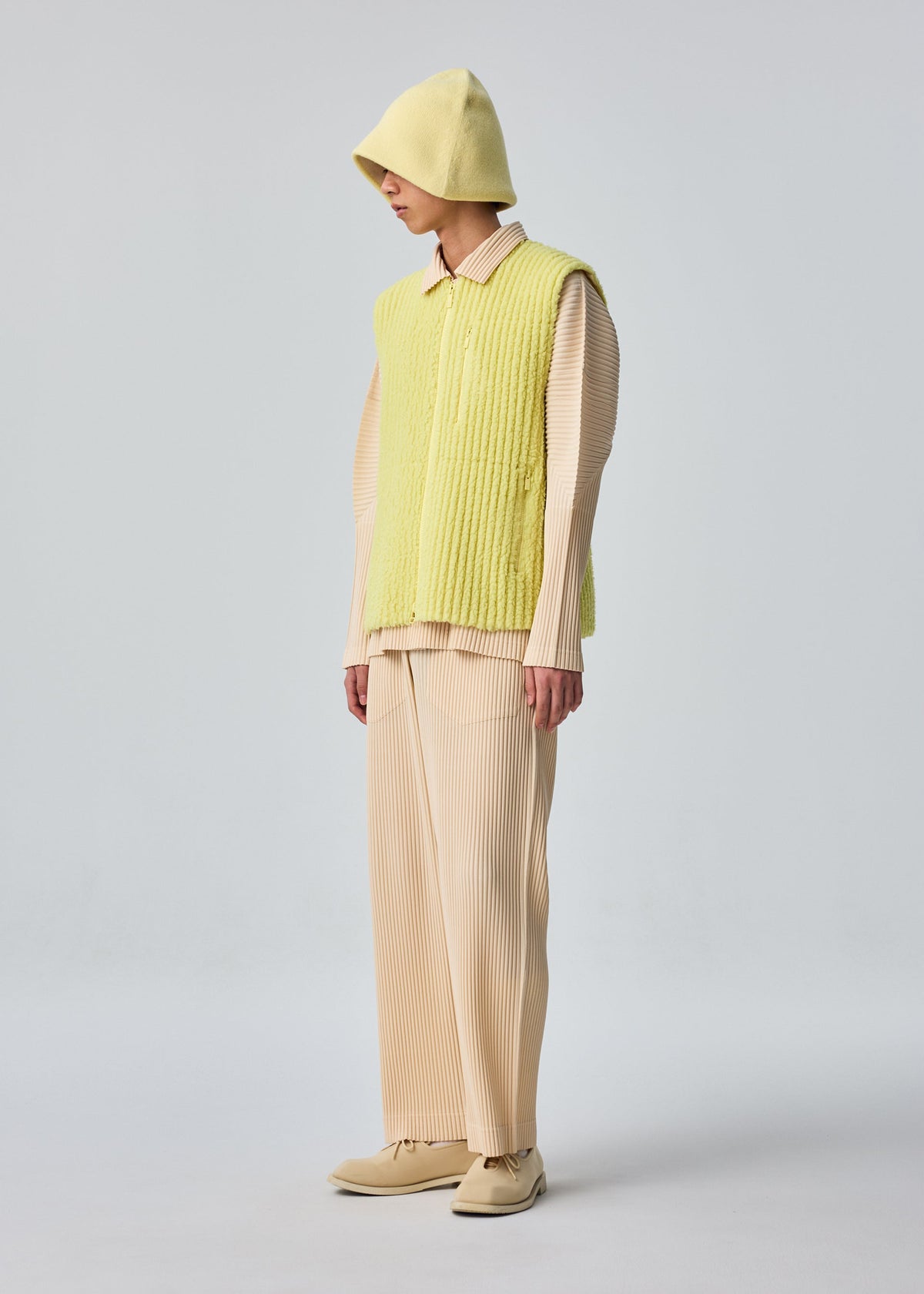 A model wears the HOMME PLISSÉ ISSEY MIYAKE FLEECE PLEATS vest.