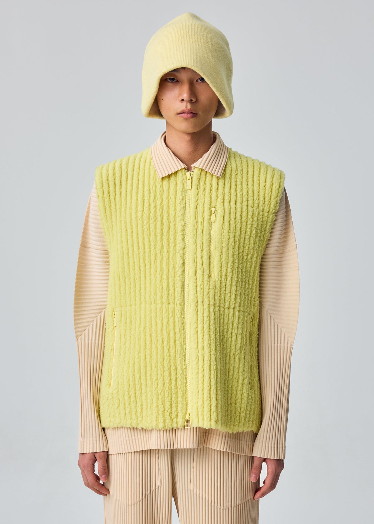 A model wears the HOMME PLISSÉ ISSEY MIYAKE FLEECE PLEATS vest.