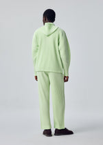 A model wears the HOMME PLISSÉ ISSEY MIYAKE MONTHLY COLORS : JULY monthly-colors-july-trousers-black.