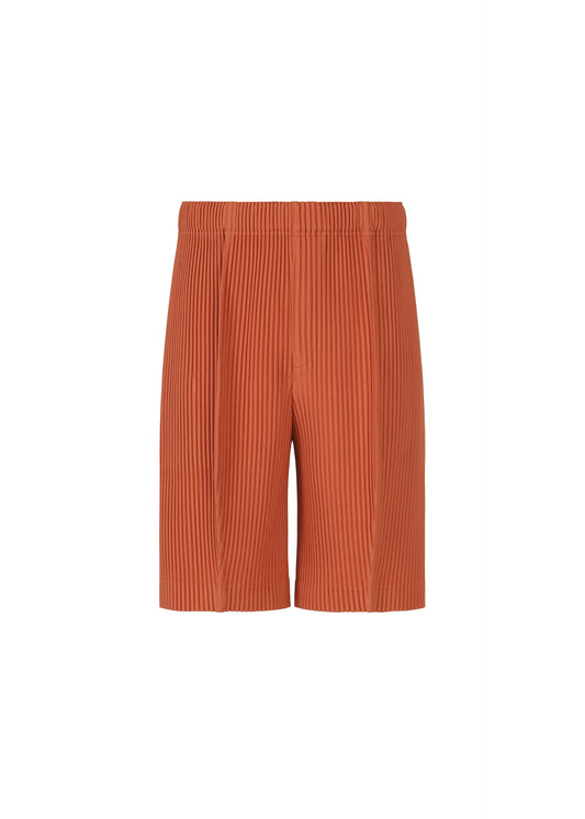 A product shot of the HOMME PLISSÉ ISSEY MIYAKE MONTHLY COLORS : AUGUST pants in shade vermillion.