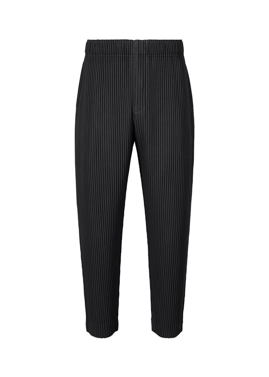 A product shot of the HOMME PLISSÉ ISSEY MIYAKE MONTHLY COLORS : AUGUST pants in black.