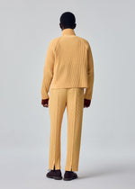 A model wears the HOMME PLISSÉ ISSEY MIYAKE TAILORED PLEATS 1 tailored-pleats-1-trousers-black-10.