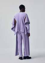 A model wears the HOMME PLISSÉ ISSEY MIYAKE MOTION BLUR motion-blur-trousers-darkside-brown-1.