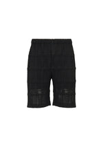 A product shot of the HOMME PLISSÉ ISSEY MIYAKE LACE GRID PLEATS pants in black.