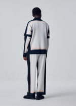 A model wears the HOMME PLISSÉ ISSEY MIYAKE FRAMEWORK : CHUSEN trousers.
