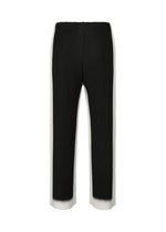 A detail shot of the HOMME PLISSÉ ISSEY MIYAKE FRAMEWORK : CHUSEN trousers.