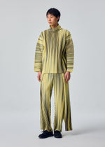 A model wears the HOMME PLISSÉ ISSEY MIYAKE BLEND OF LIGHTS blend-of-lights-trousers-brown-3.
