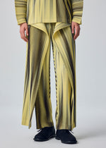 A model wears the HOMME PLISSÉ ISSEY MIYAKE BLEND OF LIGHTS blend-of-lights-trousers-brown-3.