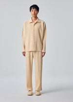 A model wears the HOMME PLISSÉ ISSEY MIYAKE MONTHLY COLORS : OCTOBER shirt.